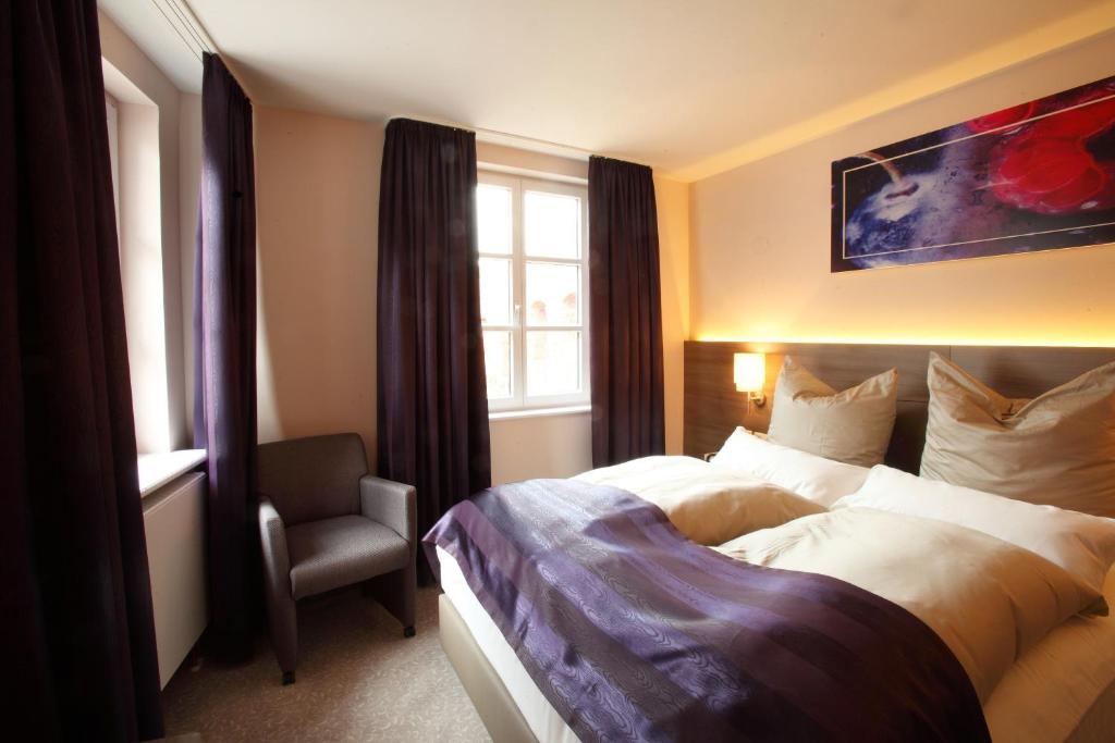 Modernes Doppelbett-Zimmer mit violetten Akzenten im Hotel MainChateau Inh. Francesco Sorrentino
